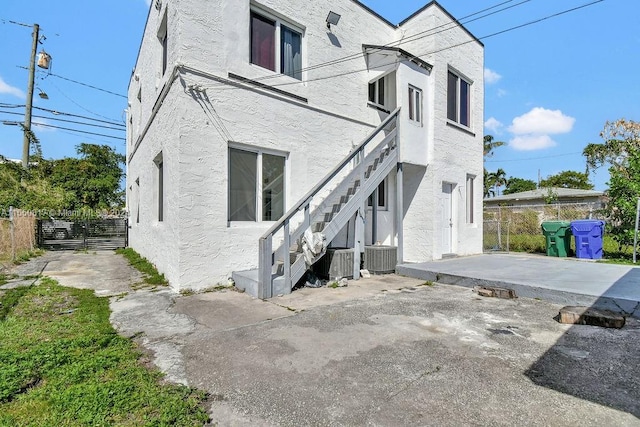 view of front of home featuring a patio and central AC