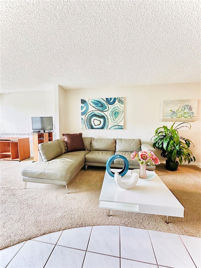 tiled living room featuring a textured ceiling