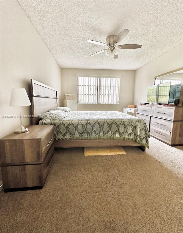 bedroom featuring ceiling fan, carpet floors, and a textured ceiling