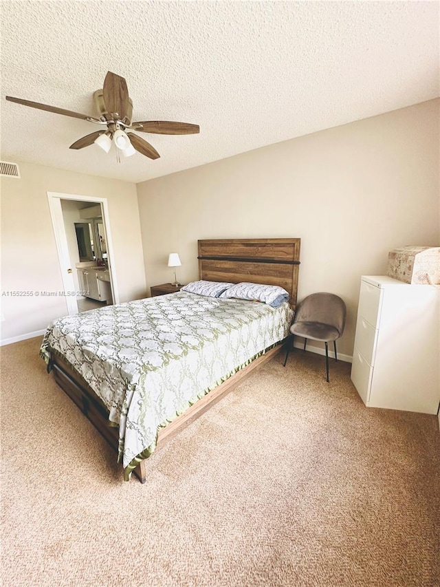 bedroom with ceiling fan, carpet floors, and a textured ceiling