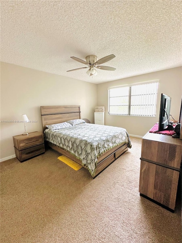 bedroom featuring carpet flooring, a textured ceiling, and ceiling fan