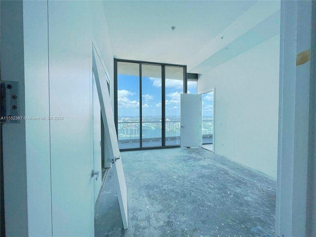 unfurnished room with a water view