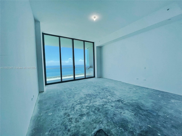 unfurnished room with a water view