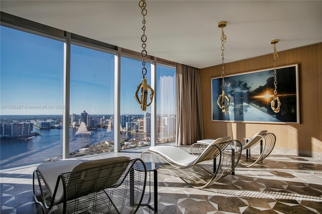 interior space with a water view and wood walls