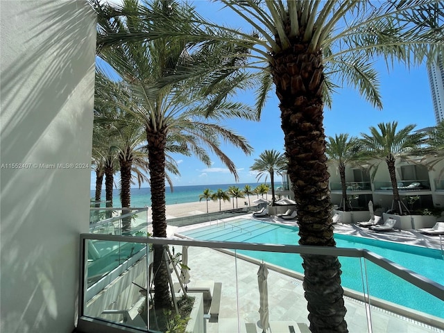 view of swimming pool with a water view