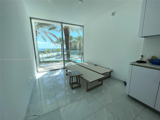 interior space featuring light tile flooring and expansive windows