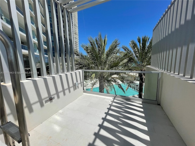 balcony featuring a fenced in pool