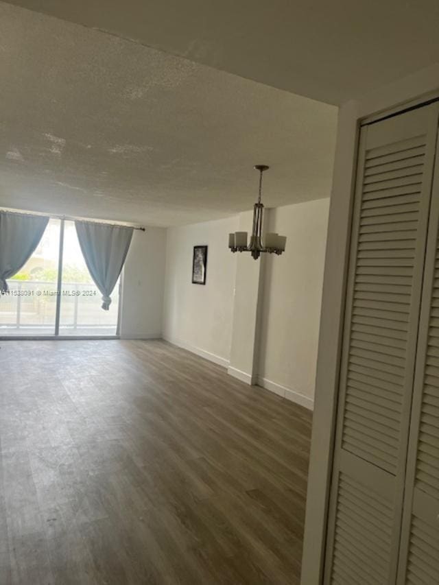 interior space with a notable chandelier and dark hardwood / wood-style flooring