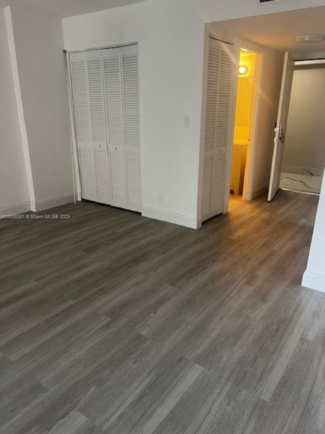 unfurnished bedroom featuring dark wood-type flooring