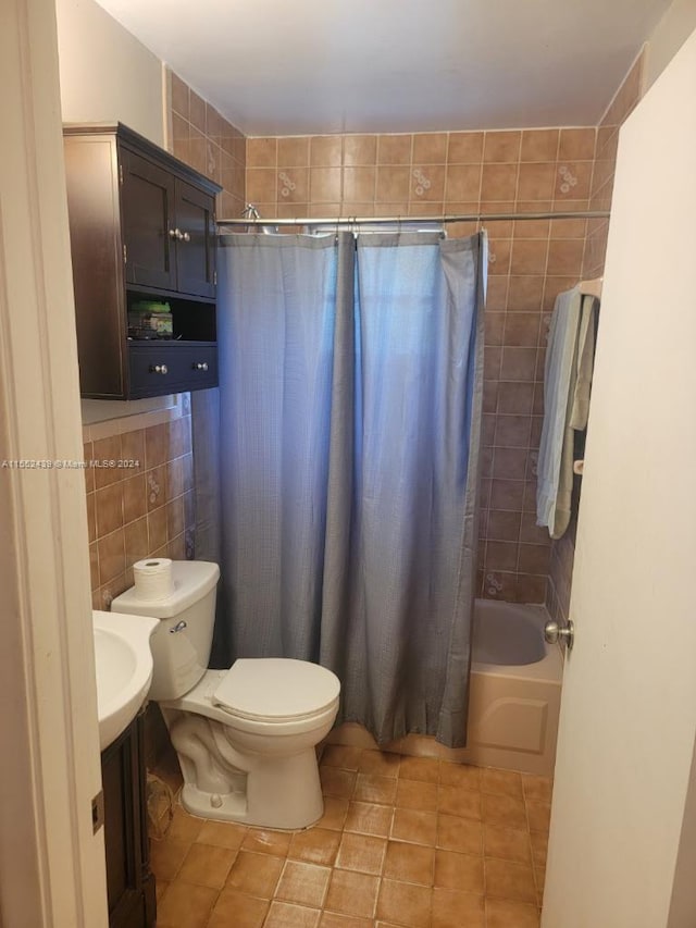 full bathroom featuring toilet, tile patterned flooring, tile walls, vanity, and shower / bathtub combination with curtain