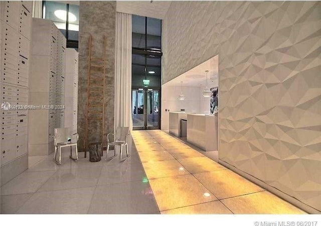 bathroom featuring tile flooring and a towering ceiling