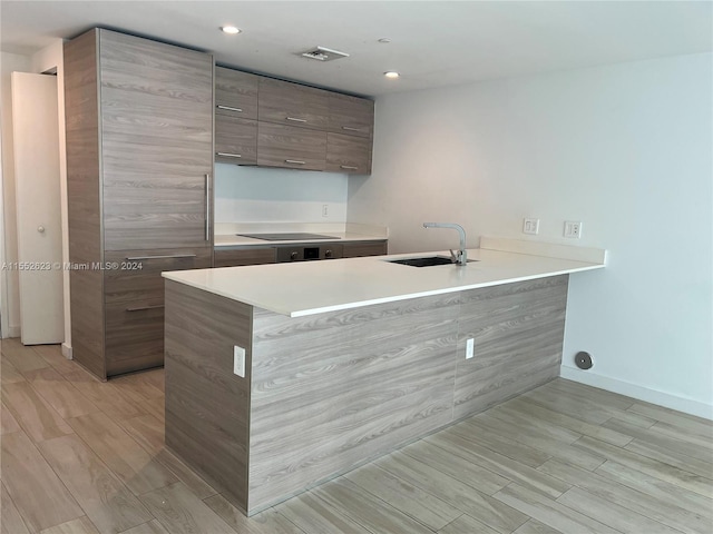 kitchen with black electric cooktop and sink