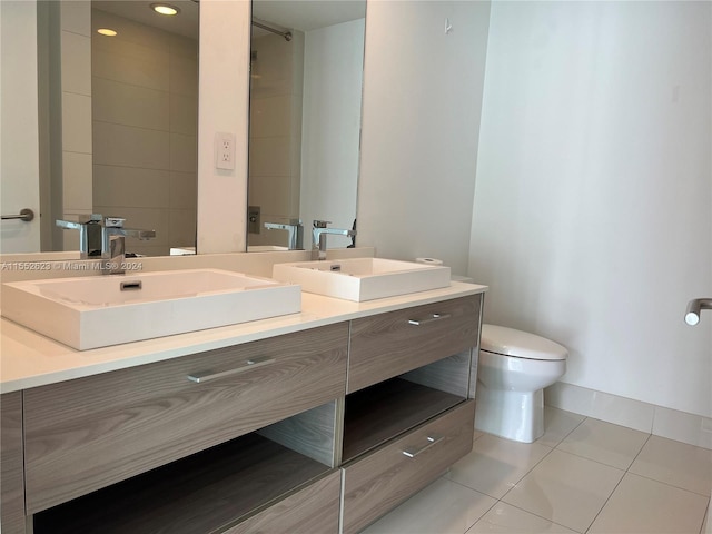 bathroom featuring vanity, tile flooring, and toilet