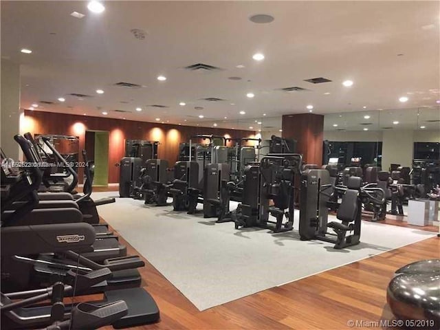 exercise room with light hardwood / wood-style flooring