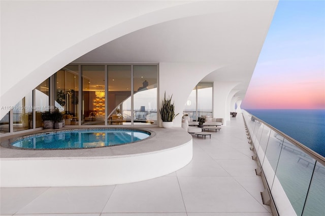 pool at dusk with a water view