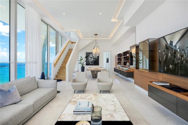 living room featuring floor to ceiling windows and light tile floors