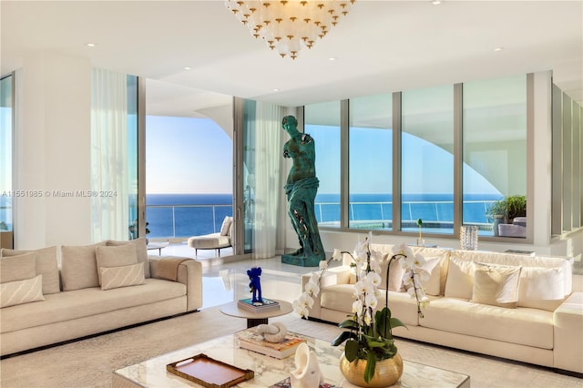 living room with a notable chandelier and a water view