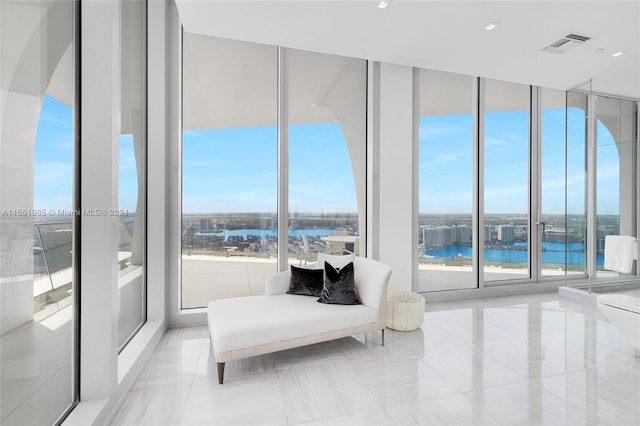 interior space featuring expansive windows and a water view