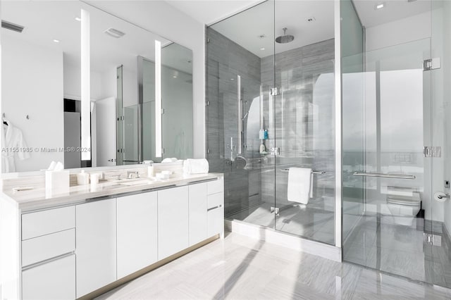 bathroom featuring a shower with shower door, toilet, tile floors, and vanity