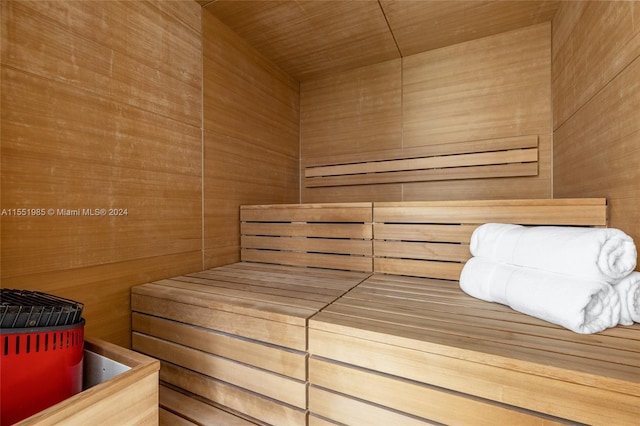 view of sauna with wood ceiling and wood walls