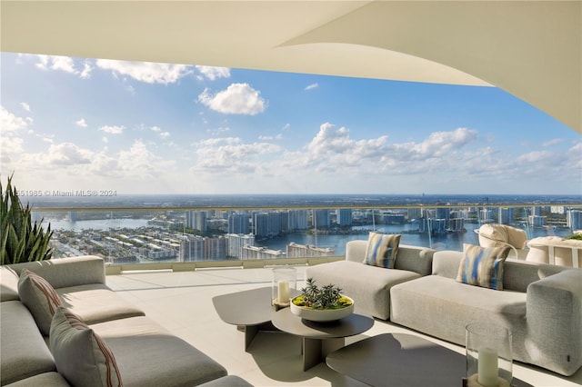 balcony with a water view and an outdoor hangout area