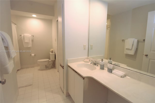 bathroom featuring tile floors, oversized vanity, and toilet