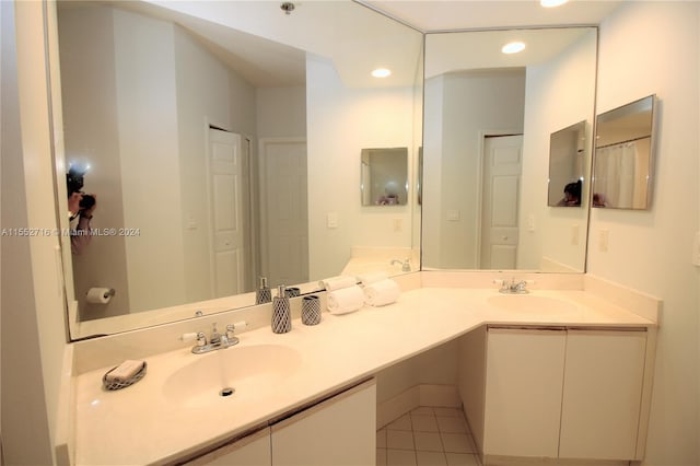 bathroom with double sink vanity and tile flooring