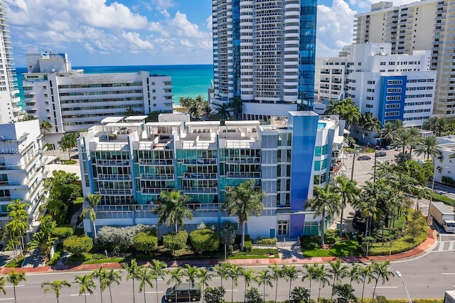 birds eye view of property with a city view and a water view