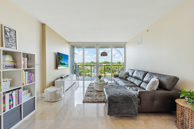 living room featuring light tile flooring and floor to ceiling windows