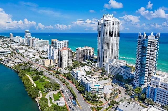 birds eye view of property with a view of city and a water view