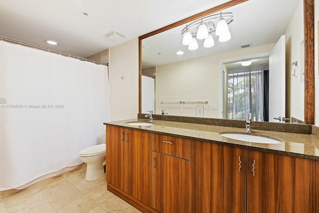 bathroom with double sink vanity, tile floors, and toilet