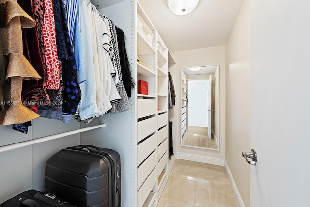 walk in closet featuring light tile floors