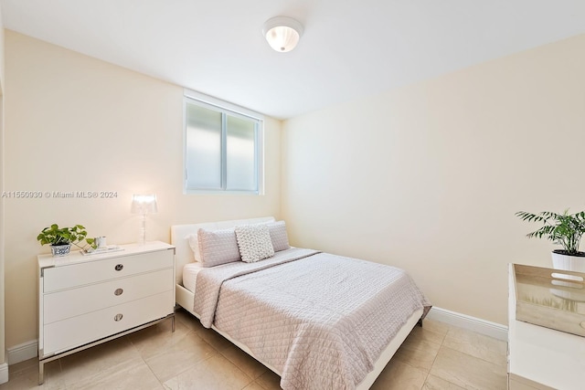 bedroom featuring light tile floors