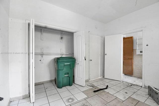 interior space featuring a closet and light tile flooring