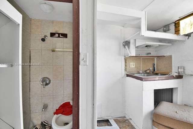 bathroom with tile flooring and tiled shower