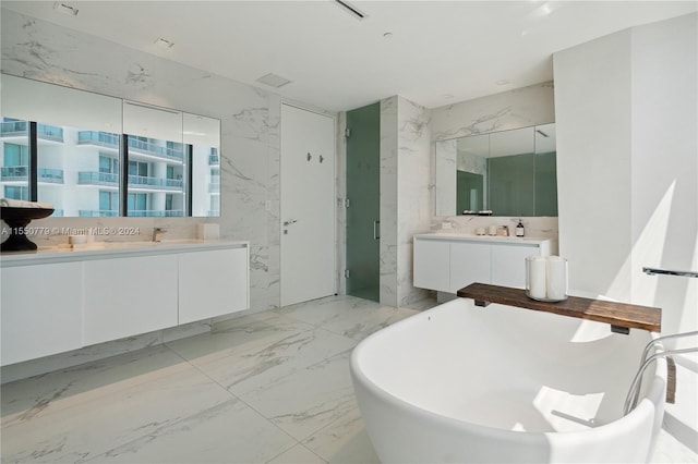 bathroom featuring tile walls, shower with separate bathtub, tile floors, and double sink vanity