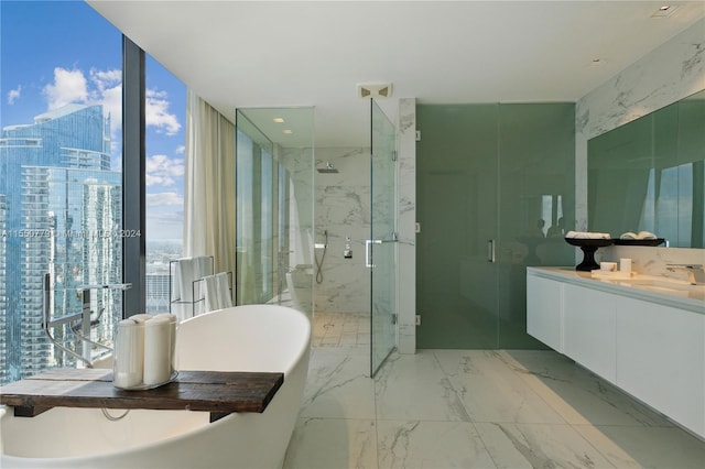 bathroom featuring vanity, shower with separate bathtub, tile flooring, and a wealth of natural light