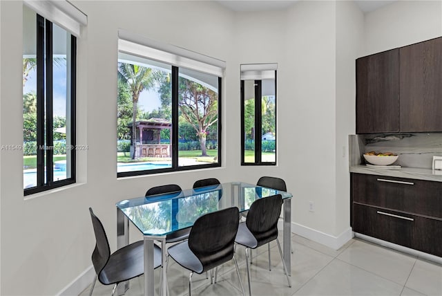 dining area with light tile floors and plenty of natural light