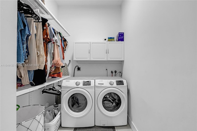 laundry area featuring hookup for a washing machine, cabinets, and washing machine and clothes dryer