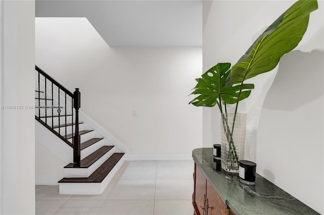 staircase with light tile floors