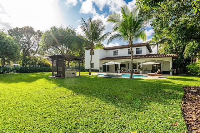 back of property featuring a yard, a pergola, and a patio area