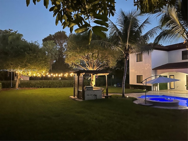 view of yard with an in ground hot tub