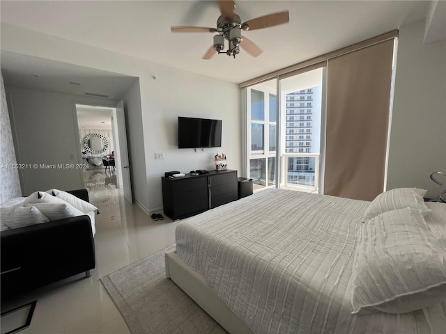 bedroom featuring a wall of windows and ceiling fan