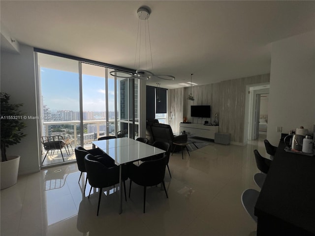 dining room with expansive windows, tile flooring, and a notable chandelier