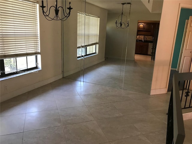 unfurnished dining area featuring light tile floors and a notable chandelier