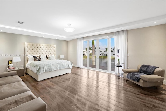 bedroom with access to exterior and dark hardwood / wood-style floors