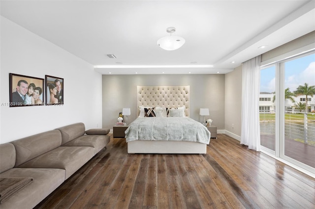 bedroom featuring access to outside and dark wood-type flooring