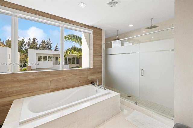 bathroom with separate shower and tub and tile flooring