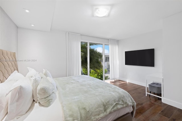 bedroom with access to exterior and dark hardwood / wood-style flooring