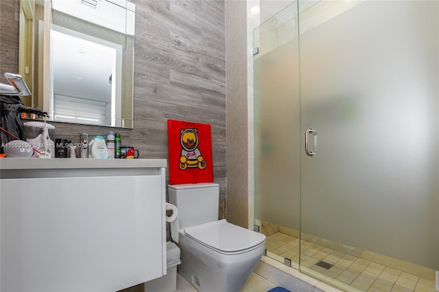 bathroom with vanity, tile floors, a shower with shower door, and toilet